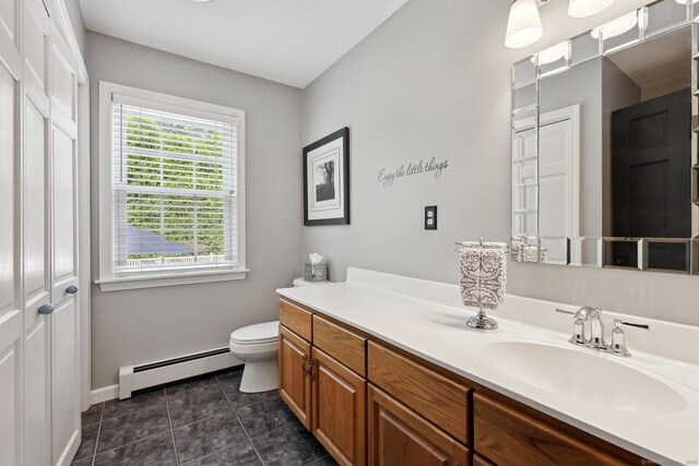1 Spinnaker Rd, Waterford, CT 06385 - bathroom featuring a baseboard radiator, toilet, vanity, tile patterned flooring, and baseboards