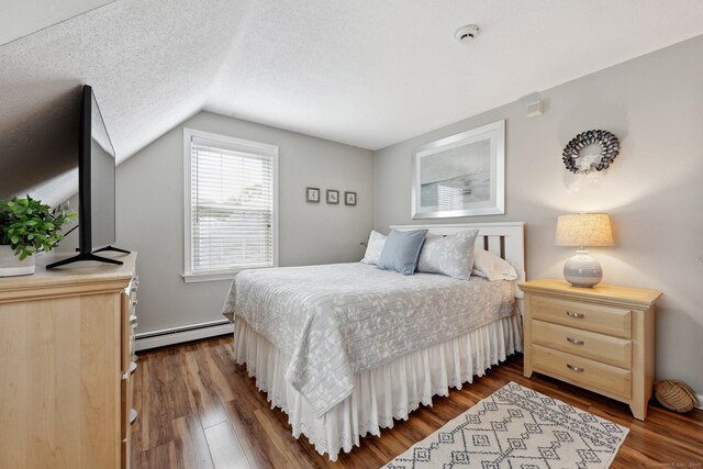 1 Spinnaker Rd, Waterford, CT 06385 - bedroom featuring a baseboard radiator, lofted ceiling, dark wood-type flooring, and a textured ceiling