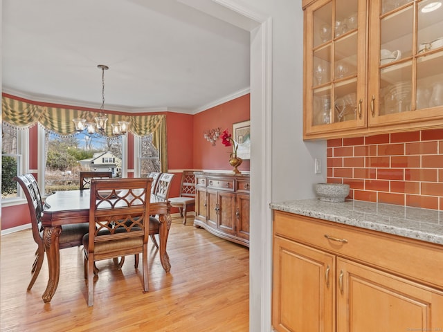 235 Lonetown Rd, Redding, CT 06896 - dining area with a chandelier, crown molding, and light wood-type flooring