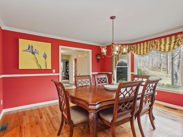 235 Lonetown Rd, Redding, CT 06896 - dining area with a chandelier, crown molding, baseboards, healthy amount of natural light, and light wood-style floors