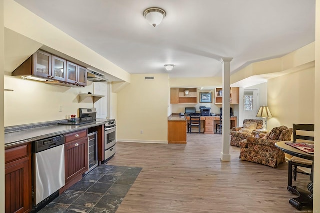235 Lonetown Rd, Redding, CT 06896 - kitchen featuring appliances with stainless steel finishes, open floor plan, dark wood-style flooring, glass insert cabinets, and dark countertops
