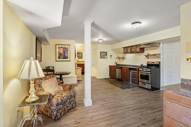 235 Lonetown Rd, Redding, CT 06896 - kitchen with appliances with stainless steel finishes, range hood, wood finished floors, and dark countertops