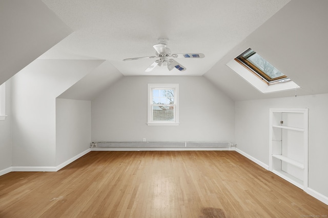 73 Camp Ave, Newington, CT 06111 - bonus room featuring light wood-style floors, a skylight, a baseboard radiator, and lofted ceiling