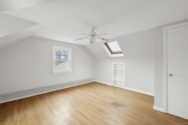 73 Camp Ave, Newington, CT 06111 - bonus room featuring built in shelves, a skylight, lofted ceiling, ceiling fan, and light wood finished floors