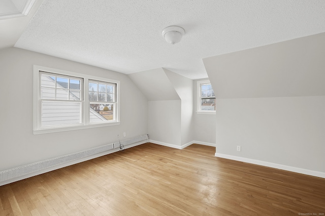 73 Camp Ave, Newington, CT 06111 - bonus room featuring vaulted ceiling, light wood-type flooring, healthy amount of natural light, and a textured ceiling