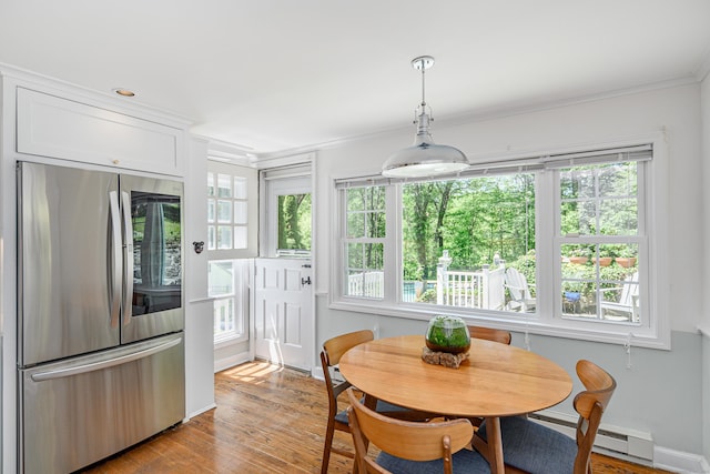 77 Crest Rd, Middlebury, CT 06762 - dining area with plenty of natural light, ornamental molding, light wood-style flooring, and a baseboard heating unit