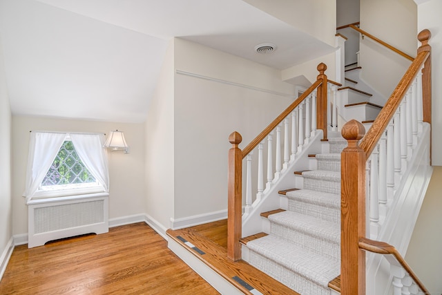 77 Crest Rd, Middlebury, CT 06762 - stairway featuring radiator heating unit, wood finished floors, and baseboards