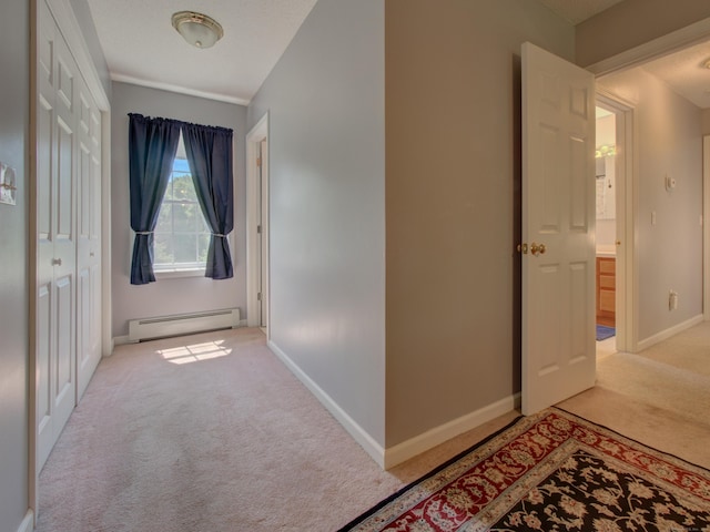 193 Pickett Rd, Plainfield, CT 06374 - corridor with a baseboard heating unit, light carpet, and baseboards