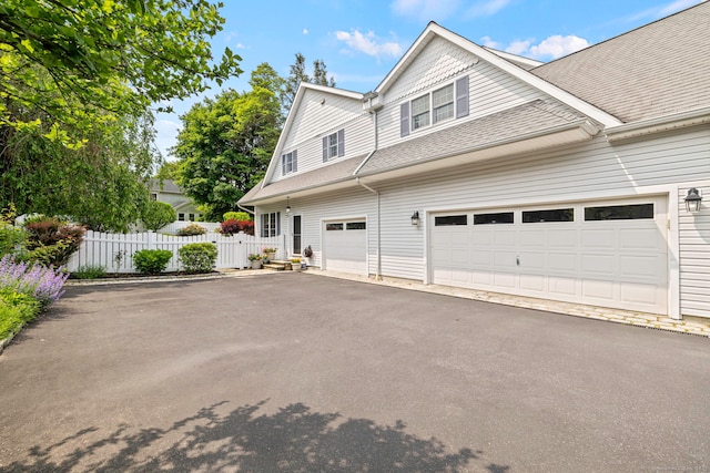 55 Perry Ln, Stratford, CT 06614 - view of front of house with asphalt driveway and roof with shingles
