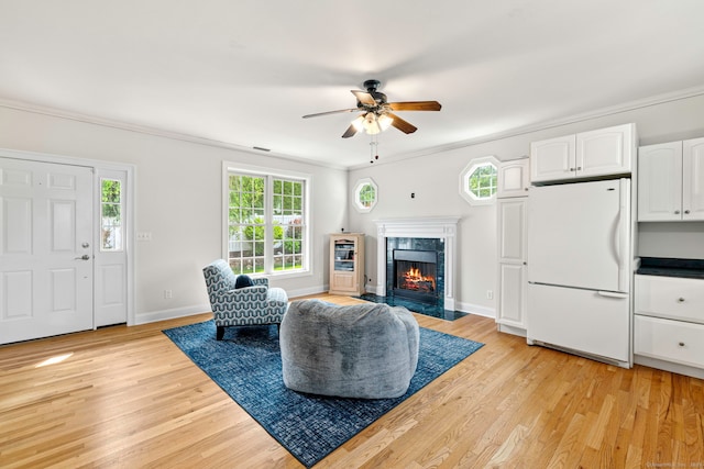 55 Perry Ln, Stratford, CT 06614 - living area with a ceiling fan, light wood-style flooring, ornamental molding, a premium fireplace, and baseboards