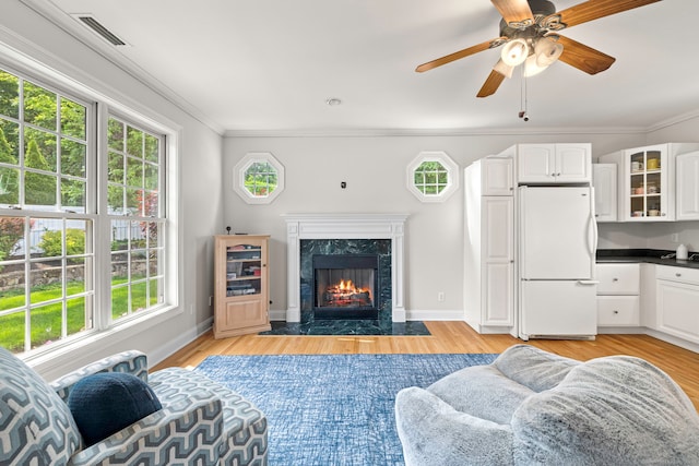 55 Perry Ln, Stratford, CT 06614 - living area featuring ornamental molding, a ceiling fan, light wood-type flooring, baseboards, and a fireplace