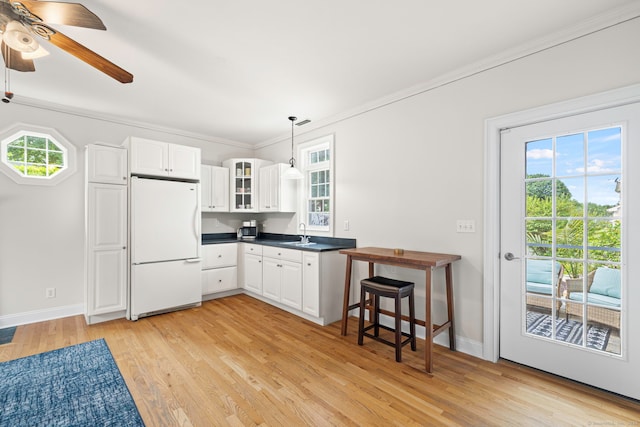 55 Perry Ln, Stratford, CT 06614 - kitchen featuring freestanding refrigerator, a sink, light wood-style floors, plenty of natural light, and ornamental molding
