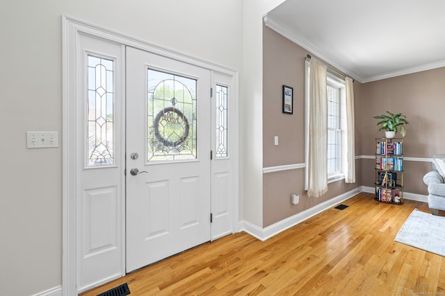 55 Perry Ln, Stratford, CT 06614 - entryway with light wood-type flooring, healthy amount of natural light, ornamental molding, and baseboards