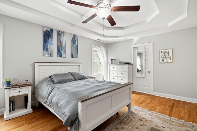 55 Perry Ln, Stratford, CT 06614 - bedroom featuring a raised ceiling, light wood-style floors, baseboards, and a ceiling fan