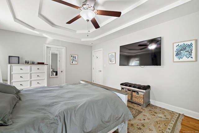 55 Perry Ln, Stratford, CT 06614 - bedroom featuring a raised ceiling, baseboards, a ceiling fan, and light wood-style flooring