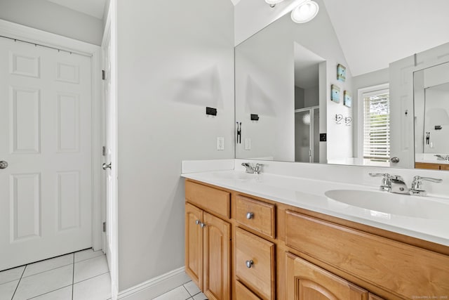55 Perry Ln, Stratford, CT 06614 - bathroom featuring tile patterned floors, double vanity, a stall shower, vaulted ceiling, and baseboards