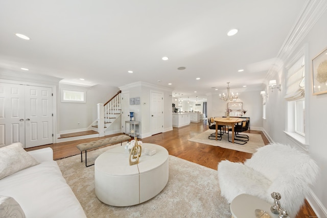 334 W Ave, Darien, CT 06820 - living area with stairs, light wood-type flooring, ornamental molding, recessed lighting, and a chandelier