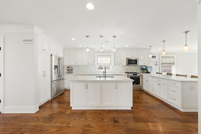 334 W Ave, Darien, CT 06820 - kitchen with stainless steel appliances, a sink, white cabinets, backsplash, and crown molding
