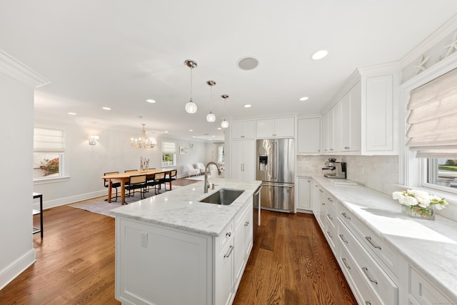 334 W Ave, Darien, CT 06820 - kitchen with a sink, stainless steel fridge, healthy amount of natural light, white cabinetry, and crown molding