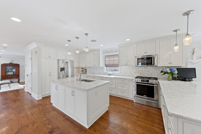 334 W Ave, Darien, CT 06820 - kitchen featuring appliances with stainless steel finishes, a sink, white cabinets, decorative backsplash, and ornamental molding