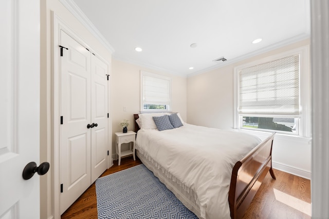 334 W Ave, Darien, CT 06820 - bedroom with multiple windows, crown molding, dark wood-style flooring, a closet, and recessed lighting