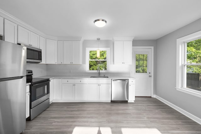 37 View St, East Haven, CT 06512 - kitchen featuring appliances with stainless steel finishes, a sink, light countertops, white cabinetry, and backsplash
