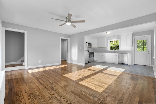 37 View St, East Haven, CT 06512 - unfurnished living room with a sink, ceiling fan, baseboards, wood finished floors, and stairway