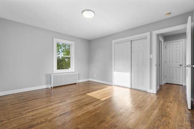 37 View St, East Haven, CT 06512 - unfurnished bedroom with radiator, wood finished floors, baseboards, and a closet