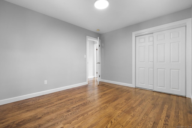 37 View St, East Haven, CT 06512 - unfurnished bedroom with baseboards, wood finished floors, and a closet