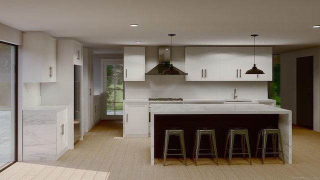 67 Carter St, New Canaan, CT 06840 - kitchen with wall chimney exhaust hood, gas cooktop, a sink, light stone countertops, and a center island