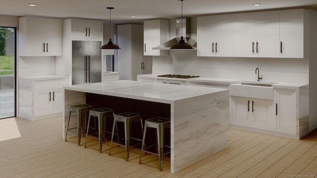 67 Carter St, New Canaan, CT 06840 - kitchen featuring wall chimney range hood, a sink, light wood finished floors, a kitchen island, and stainless steel refrigerator