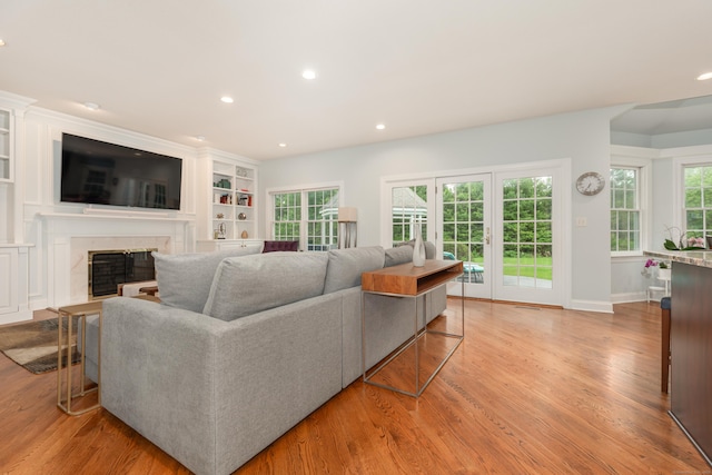 3 Mountaincrest Dr, Cheshire, CT 06410 - living area with light wood-type flooring, a premium fireplace, recessed lighting, built in shelves, and baseboards