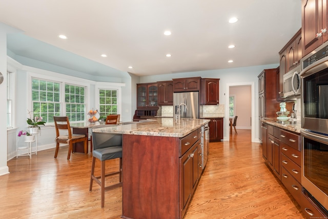 3 Mountaincrest Dr, Cheshire, CT 06410 - kitchen featuring stainless steel appliances, a kitchen breakfast bar, decorative backsplash, recessed lighting, and an island with sink