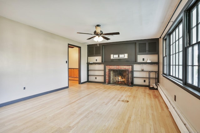 86 Rice Rd, Meriden, CT 06450 - unfurnished living room featuring a baseboard radiator, light wood-type flooring, a brick fireplace, ceiling fan, and baseboards