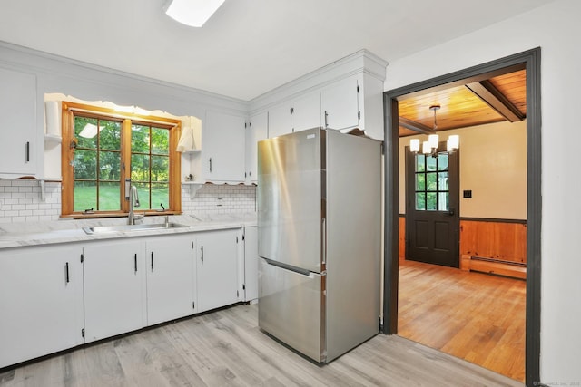 86 Rice Rd, Meriden, CT 06450 - kitchen featuring freestanding refrigerator, a sink, baseboard heating, light wood finished floors, and tasteful backsplash