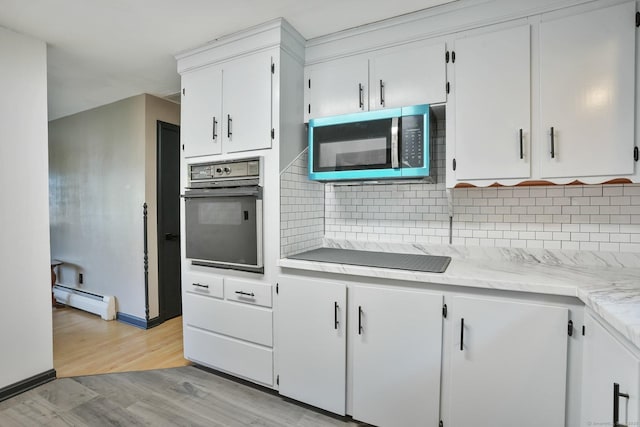 86 Rice Rd, Meriden, CT 06450 - kitchen featuring oven, stainless steel microwave, a baseboard heating unit, electric stovetop, and light wood-type flooring