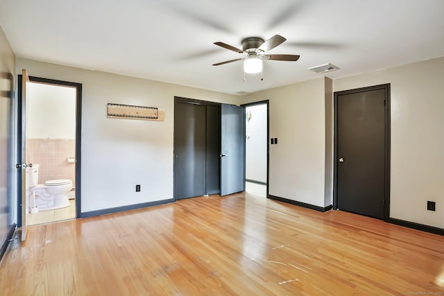 86 Rice Rd, Meriden, CT 06450 - unfurnished bedroom with multiple closets, baseboards, light wood-type flooring, a ceiling fan, and connected bathroom