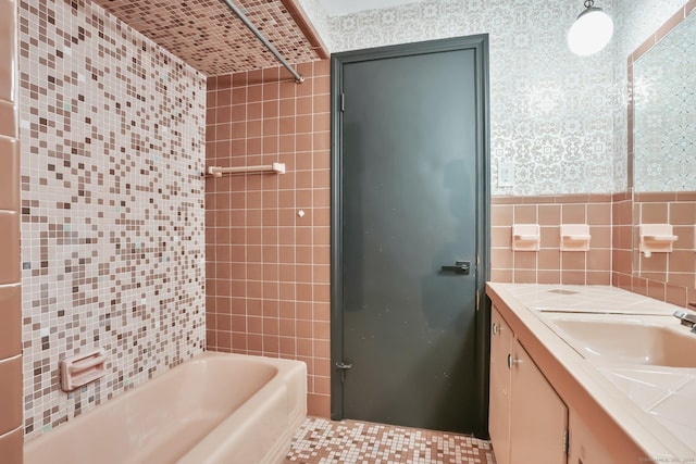 86 Rice Rd, Meriden, CT 06450 - bathroom with tile walls, double vanity, wallpapered walls, and bathtub / shower combination