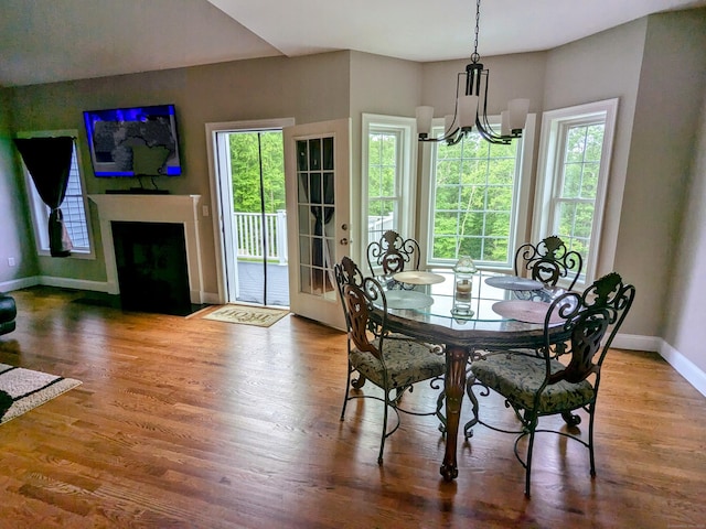 5 Newberry St, Haddam, CT 06441 - dining room with baseboards, a chandelier, wood finished floors, and a fireplace with flush hearth