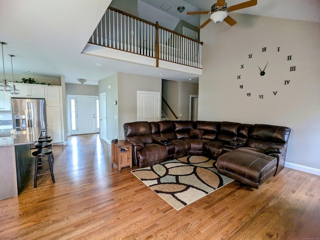 5 Newberry St, Haddam, CT 06441 - living room featuring light wood finished floors, baseboards, a ceiling fan, stairway, and a high ceiling