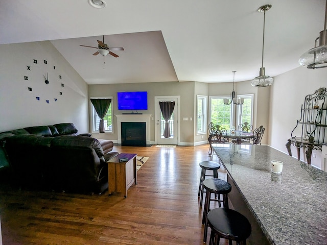 5 Newberry St, Haddam, CT 06441 - living area with healthy amount of natural light, wood finished floors, ceiling fan, vaulted ceiling, and baseboards