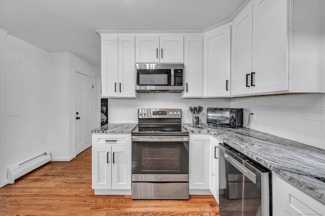 75 Carll Rd, Middletown, CT 06457 - kitchen with stainless steel appliances, a baseboard radiator, light stone countertops, wine cooler, and white cabinets