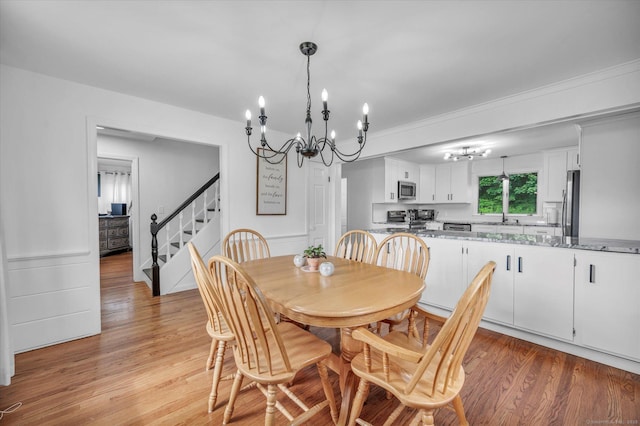75 Carll Rd, Middletown, CT 06457 - dining area featuring a chandelier, stairs, and light wood-type flooring