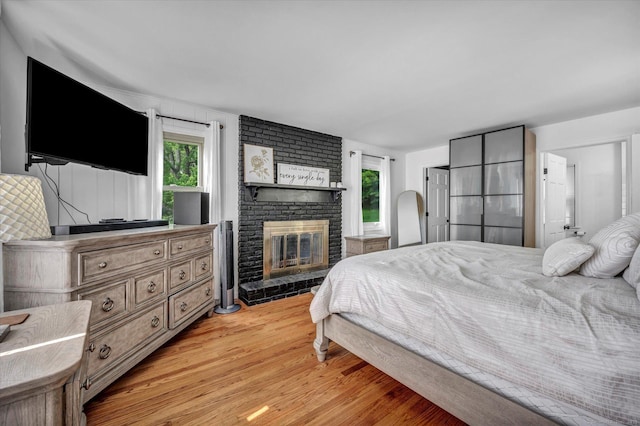 75 Carll Rd, Middletown, CT 06457 - bedroom with multiple windows, light wood-type flooring, and a fireplace
