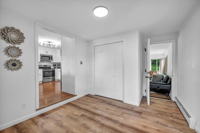 75 Carll Rd, Middletown, CT 06457 - bedroom featuring baseboard heating, light wood-style flooring, a closet, and baseboards