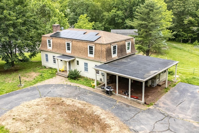 29 Daniels Rd, East Haddam, CT 06423 - view of front facade featuring a chimney, roof mounted solar panels, asphalt driveway, and a shingled roof