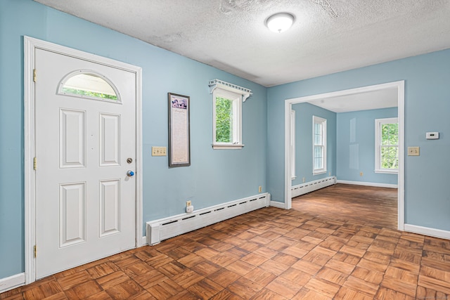 29 Daniels Rd, East Haddam, CT 06423 - foyer with a baseboard heating unit, plenty of natural light, a textured ceiling, and baseboards