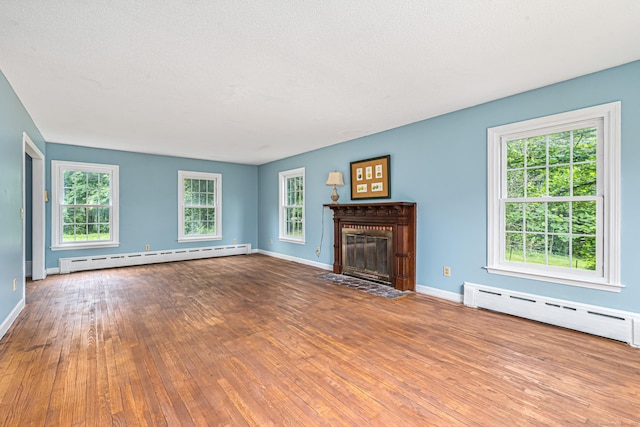 29 Daniels Rd, East Haddam, CT 06423 - unfurnished living room with a baseboard heating unit, hardwood / wood-style flooring, baseboards, and plenty of natural light