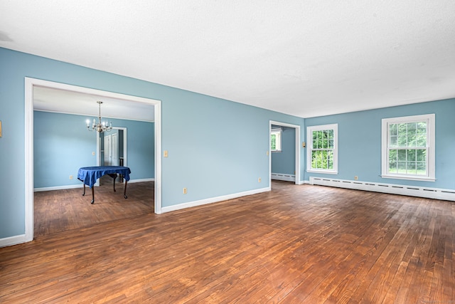 29 Daniels Rd, East Haddam, CT 06423 - empty room featuring hardwood / wood-style flooring, a chandelier, baseboard heating, and baseboards