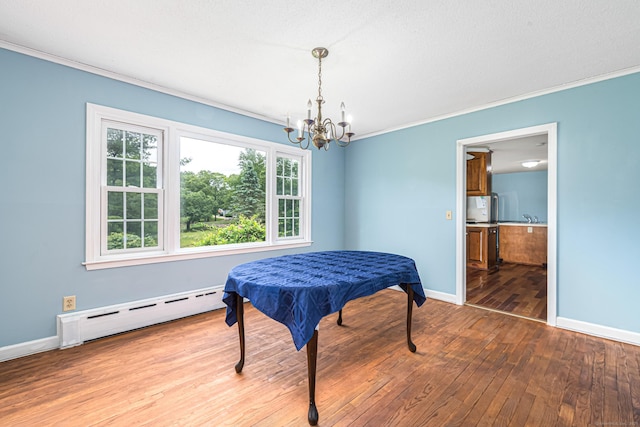 29 Daniels Rd, East Haddam, CT 06423 - dining area with a baseboard heating unit, a chandelier, hardwood / wood-style flooring, ornamental molding, and baseboards